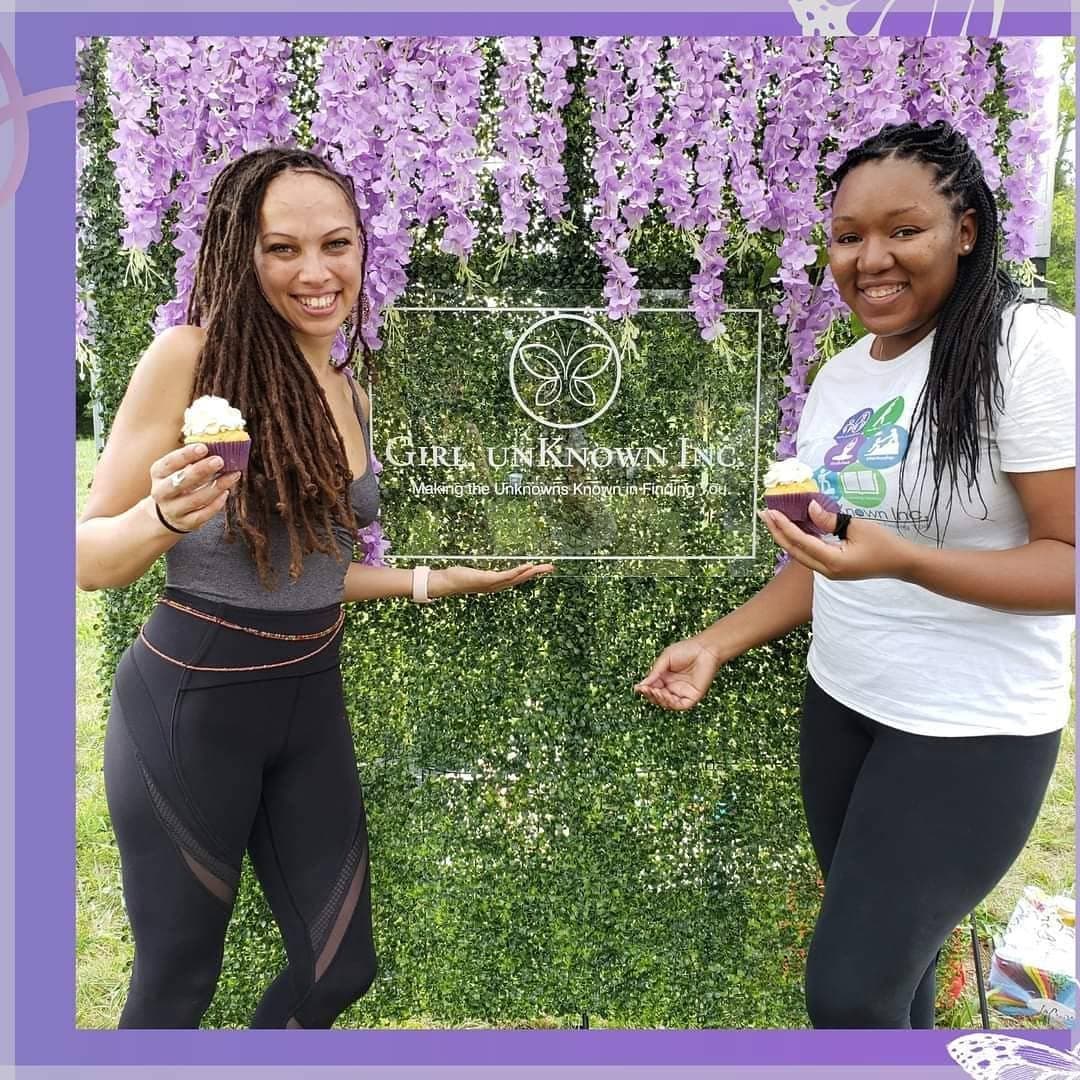 Two women at a Girl, unKnown Inc. community event