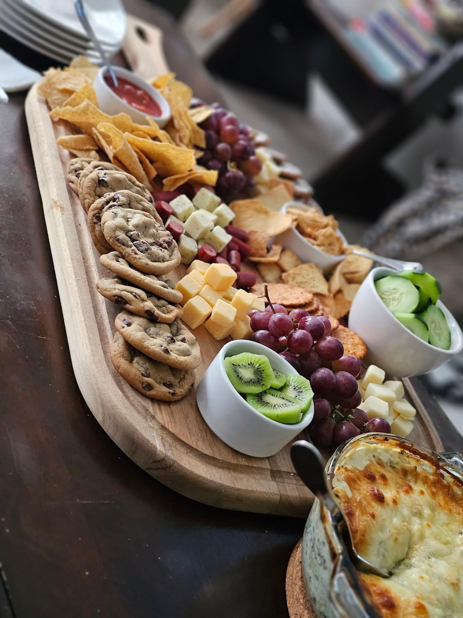 A Sunday snack board with cookies, cheese, and fruit